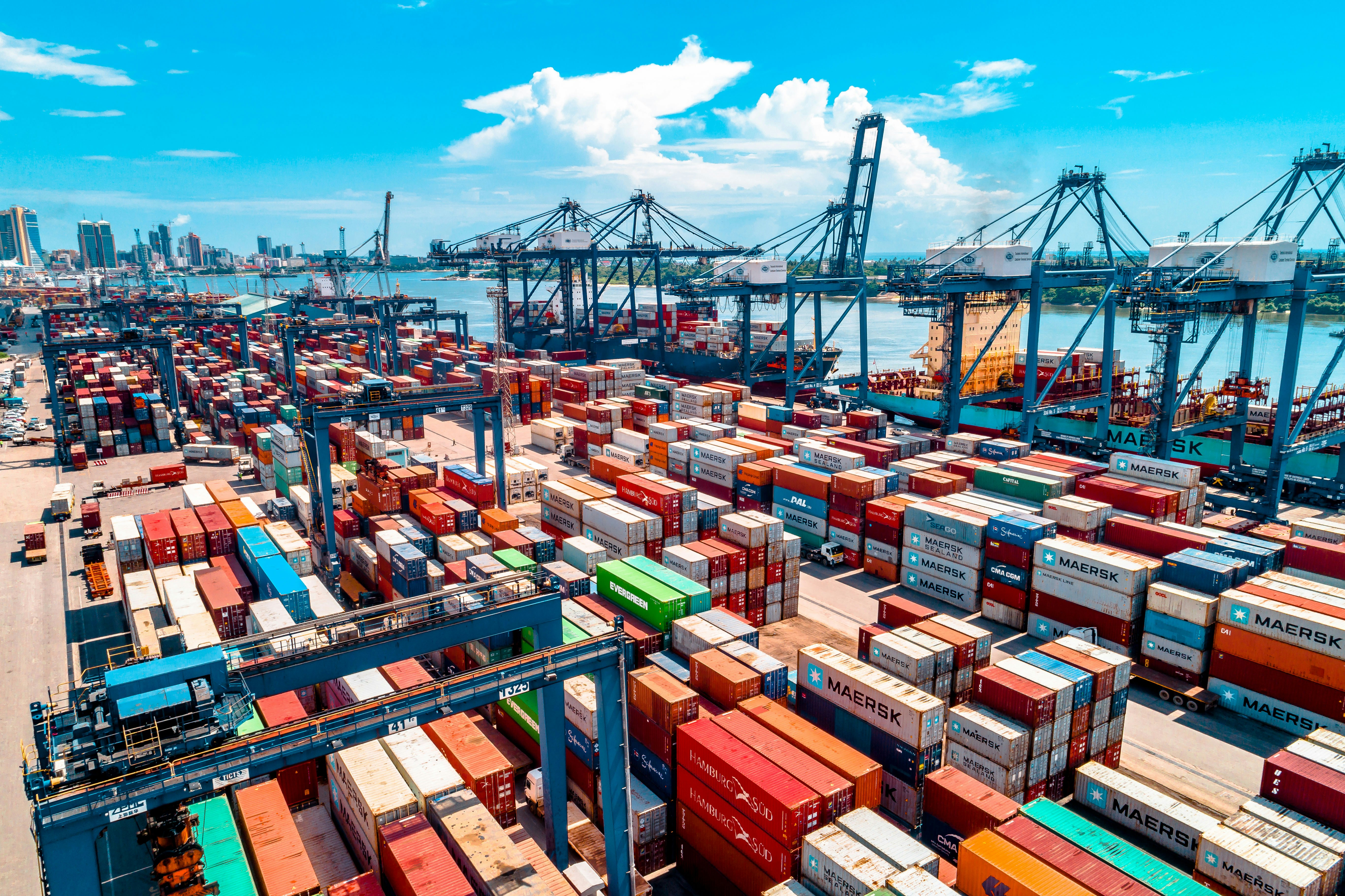 Stacked shipping containers at a Chinese export port awaiting loading